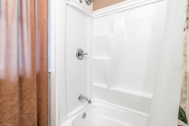 bathroom with shower / tub combo with curtain