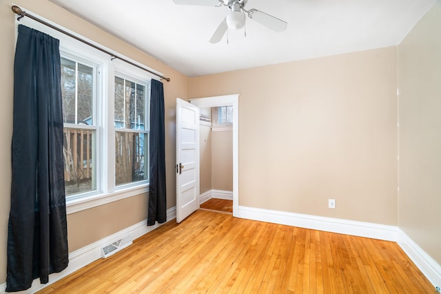 unfurnished room featuring plenty of natural light, baseboards, and visible vents