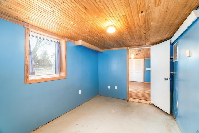 interior space featuring wood ceiling and concrete flooring