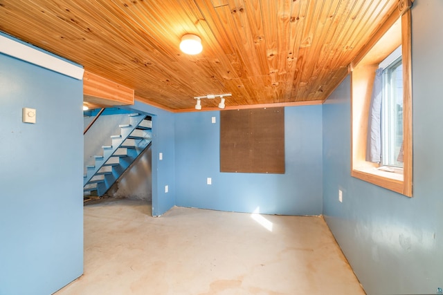 basement featuring stairs and wooden ceiling