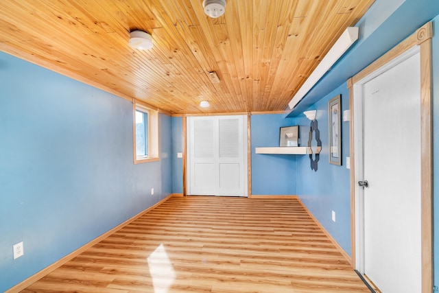 unfurnished room featuring wooden ceiling, wood finished floors, and baseboards