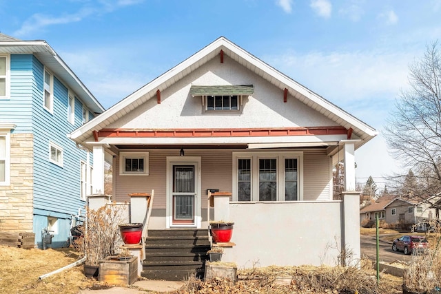 view of front of house with covered porch and stucco siding