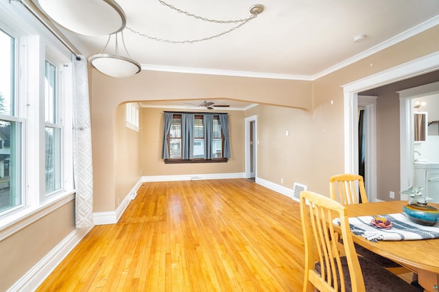 unfurnished dining area with visible vents, baseboards, ornamental molding, and light wood finished floors