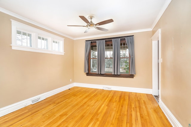 empty room with a ceiling fan, visible vents, and a wealth of natural light