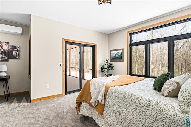 carpeted bedroom featuring access to outside, baseboards, and a wall mounted AC