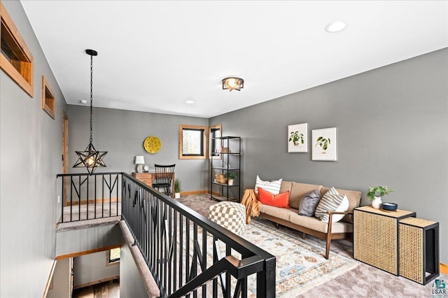 living area featuring carpet flooring and baseboards