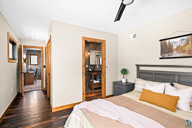 bedroom with dark wood-style floors, visible vents, and baseboards