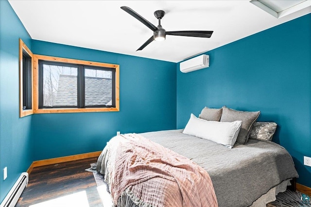 bedroom featuring a wall mounted air conditioner, a ceiling fan, wood finished floors, baseboards, and baseboard heating