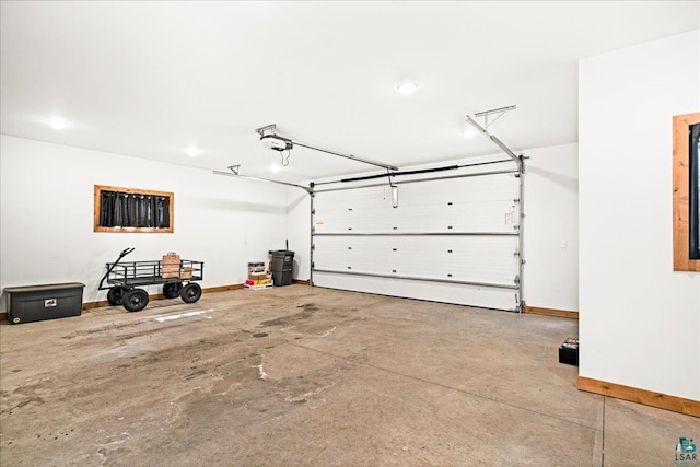 garage with a garage door opener and baseboards