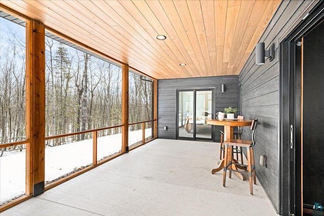 sunroom / solarium featuring plenty of natural light and wood ceiling