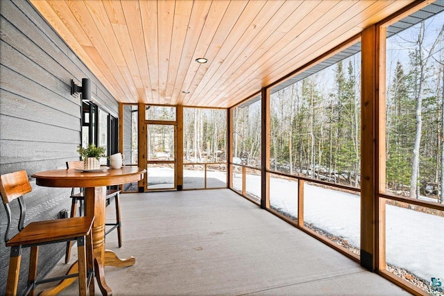 unfurnished sunroom with wooden ceiling