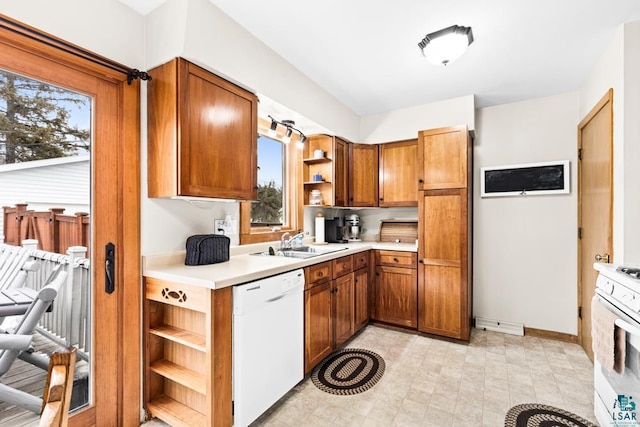 kitchen featuring open shelves, a sink, white appliances, brown cabinetry, and light countertops