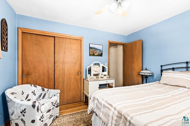 bedroom featuring a closet, ceiling fan, and wood finished floors