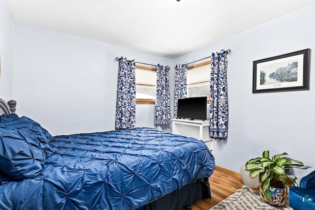 bedroom with wood finished floors