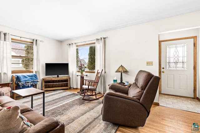 living area with a wealth of natural light and light wood-style floors