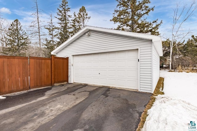 detached garage featuring fence