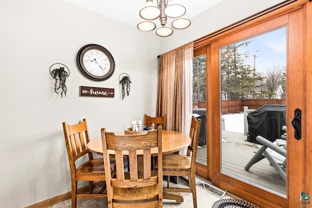 dining room with a notable chandelier, baseboards, and visible vents