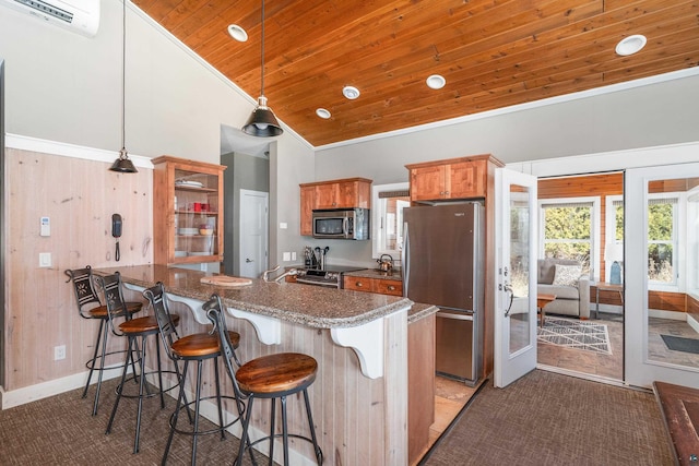 kitchen with an AC wall unit, a breakfast bar, appliances with stainless steel finishes, a peninsula, and wooden ceiling