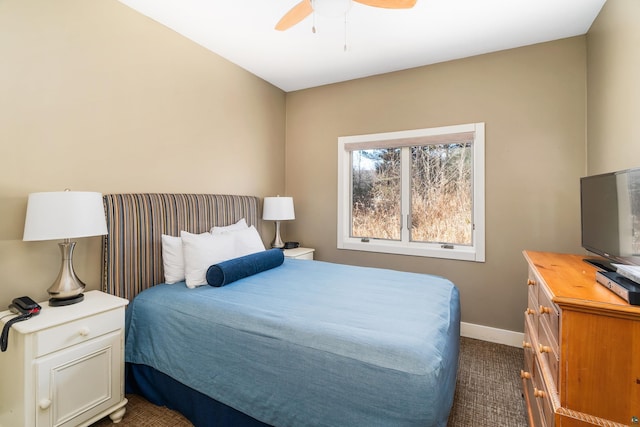 bedroom featuring a ceiling fan, baseboards, and dark colored carpet