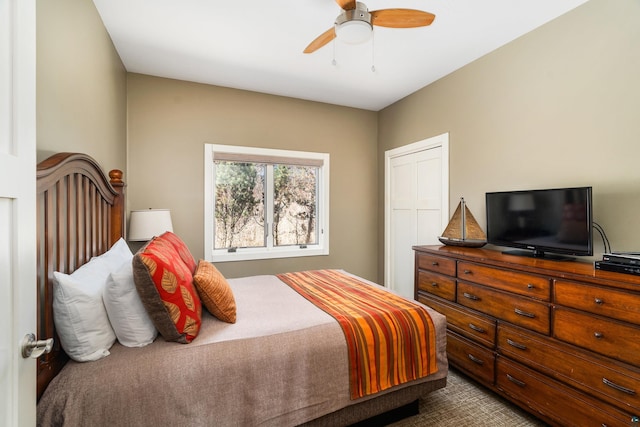 bedroom with a ceiling fan and dark colored carpet