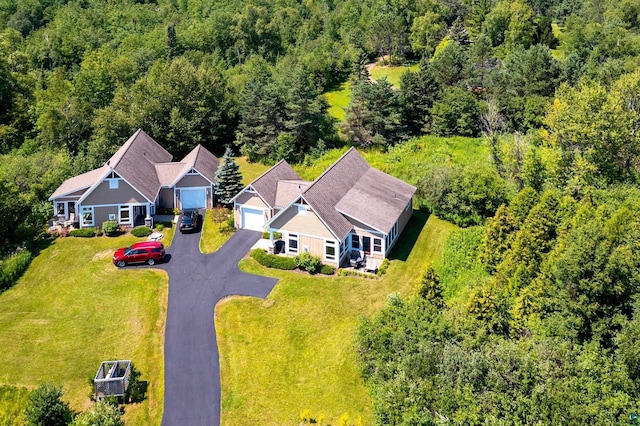 drone / aerial view with a wooded view