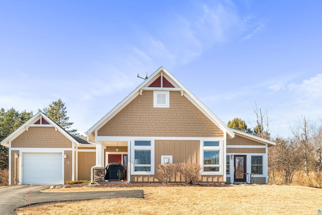 view of front of home with driveway and a garage