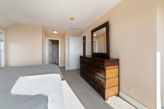 bedroom with light colored carpet and baseboards