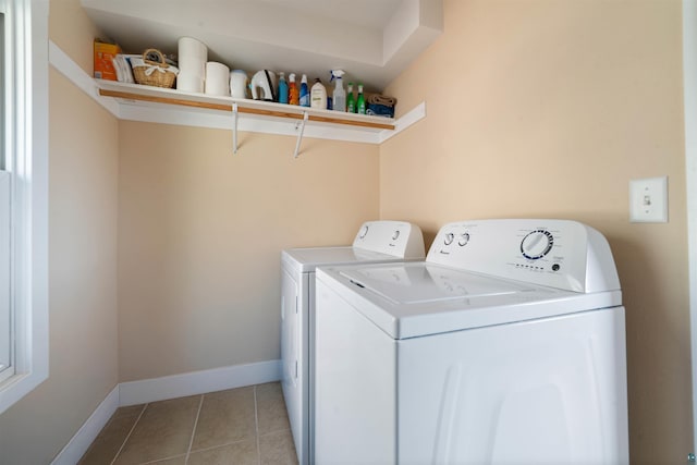 laundry area with independent washer and dryer, light tile patterned floors, baseboards, and laundry area