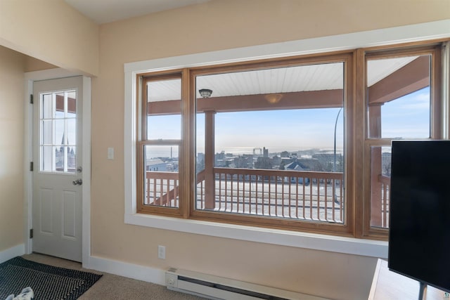 doorway with baseboards and a baseboard heating unit