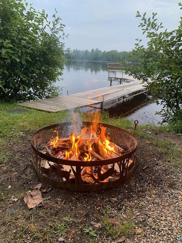 exterior space with an outdoor fire pit and a water view