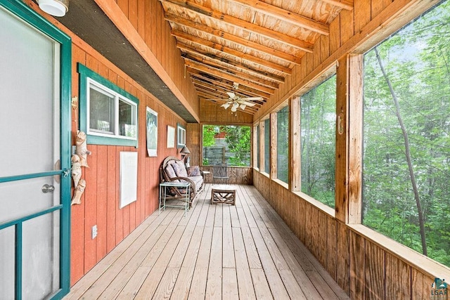 unfurnished sunroom with ceiling fan