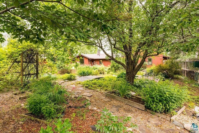 view of yard with fence and a vegetable garden