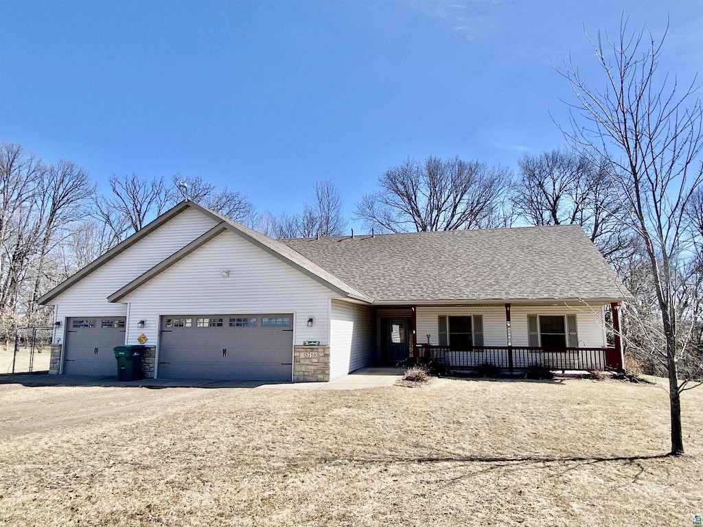 ranch-style home featuring dirt driveway, an attached garage, a shingled roof, and a porch