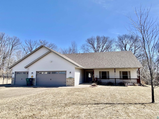 ranch-style home featuring dirt driveway, an attached garage, a shingled roof, and a porch