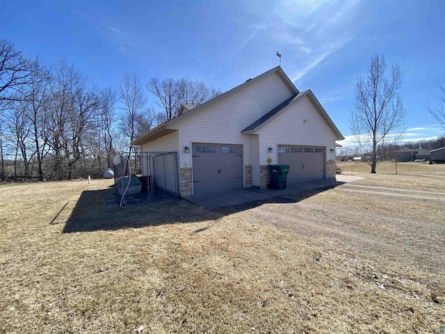 view of home's exterior with driveway and an attached garage