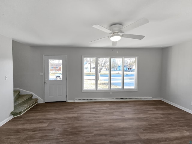 entrance foyer featuring dark wood finished floors, baseboards, baseboard heating, and ceiling fan