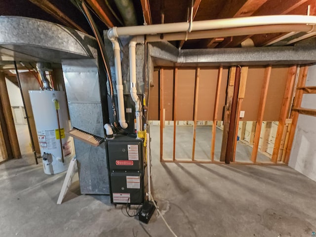 utility room with heating unit and gas water heater