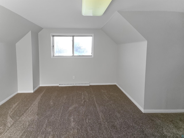 additional living space with baseboards, lofted ceiling, and a baseboard heating unit