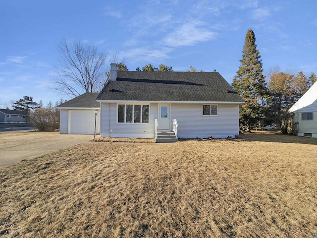 view of front of home featuring a shingled roof and a garage