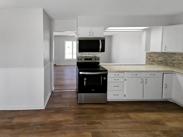 kitchen featuring light countertops, tasteful backsplash, stainless steel appliances, white cabinets, and dark wood-type flooring