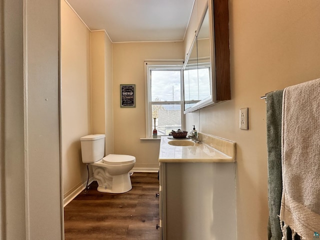 1923 W 6th St, Ashland, WI 54806 - bathroom with toilet, wood finished floors, vanity, and baseboards