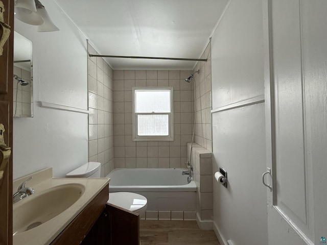 1923 W 6th St, Ashland, WI 54806 - full bath with vanity, wood finished floors, toilet, and shower / washtub combination