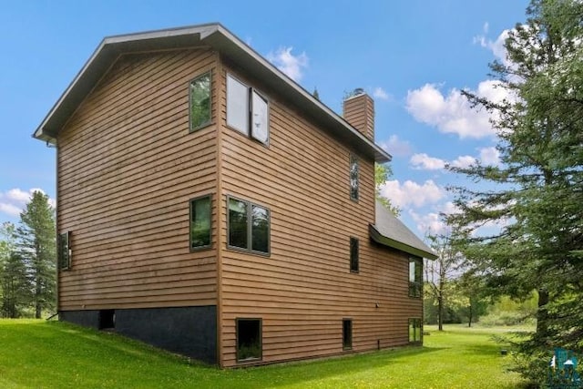 2755 County Road 1, Wrenshall, MN 55797 - view of side of property with a yard and a chimney