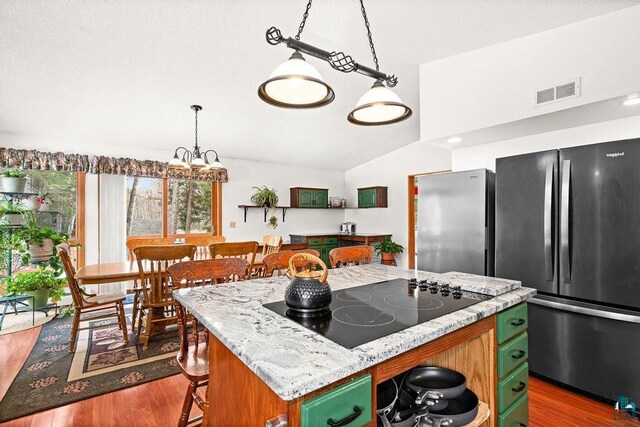 2755 County Road 1, Wrenshall, MN 55797 - kitchen featuring black electric stovetop, freestanding refrigerator, a center island, and lofted ceiling