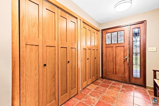 entrance foyer with light tile patterned flooring and a healthy amount of sunlight