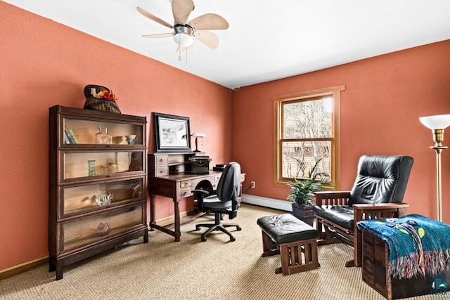 office featuring ceiling fan, baseboard heating, light carpet, and baseboards