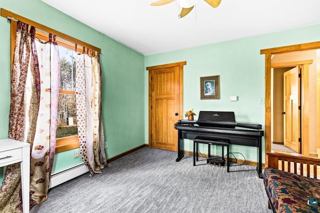 living area with carpet floors, ceiling fan, a baseboard heating unit, and baseboards