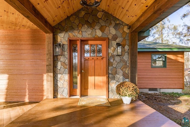 doorway to property with crawl space and stone siding