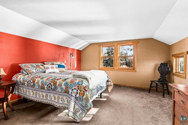 carpeted bedroom featuring baseboards and lofted ceiling