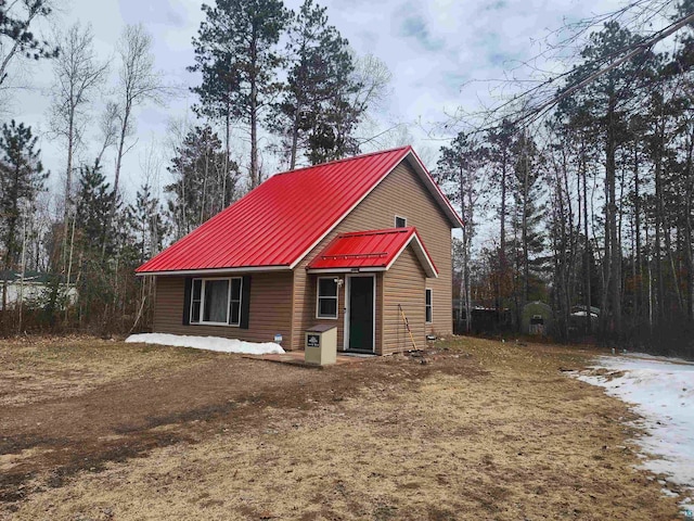 rear view of property with metal roof